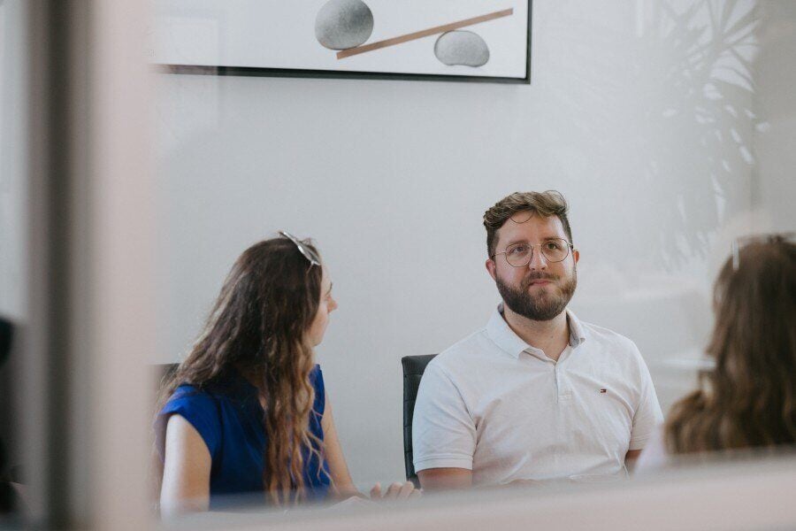 Vision33 Team members sitting in the office meeting room