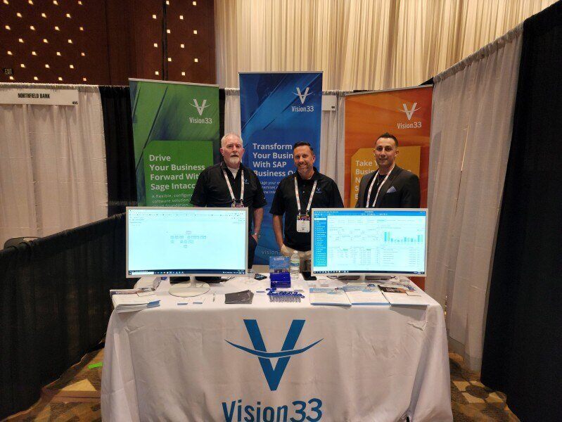 Vision33 Team Members in their Booth at a conference